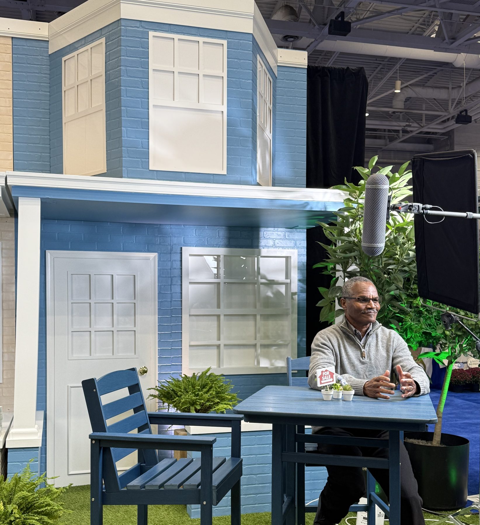 Chris Streeter seated at a model home display at a home show