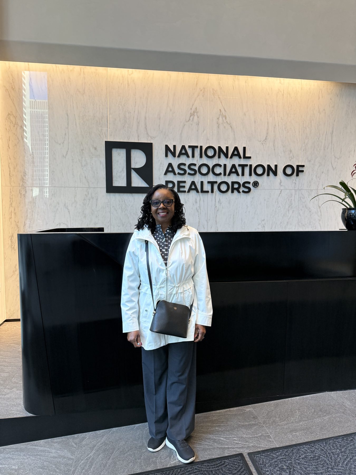 A PWR team member standing in the National Association of REALTORS® lobby